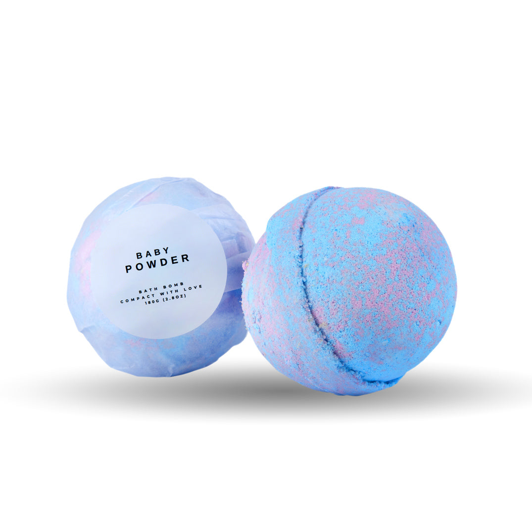 Two bath bombs, one labeled 'Baby Powder', on a white background