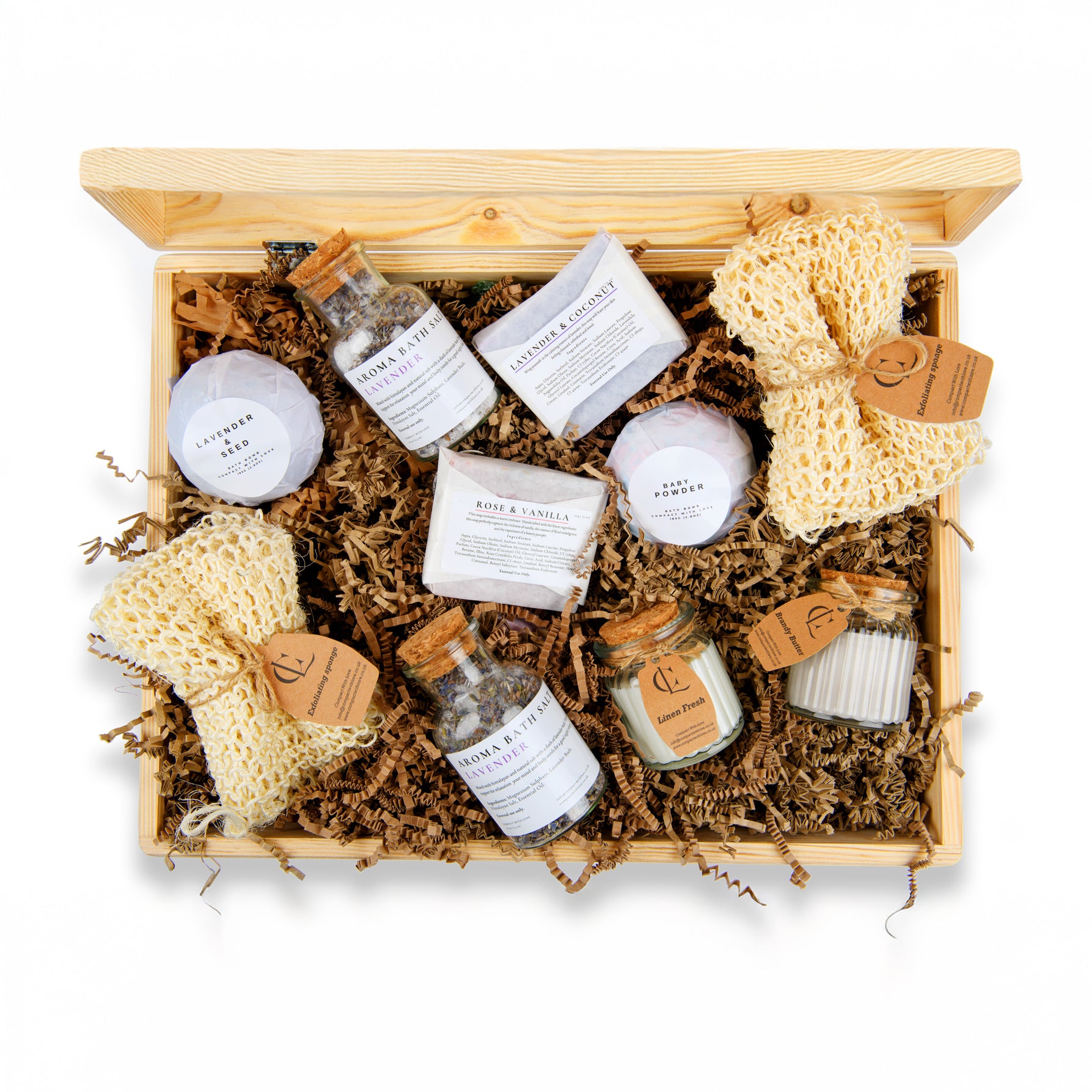 Gift set with bath products including bottles, soap, and loofahs in a wooden box.