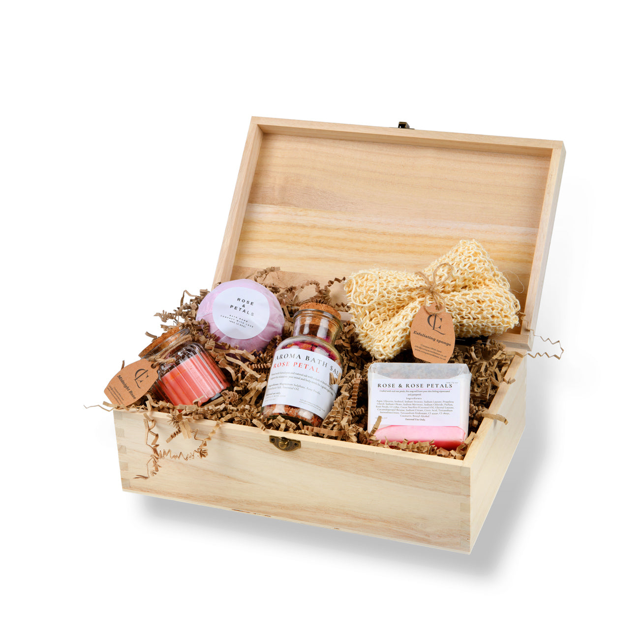 Wooden gift box with bath products including a candle, soap, and loofah on a white background