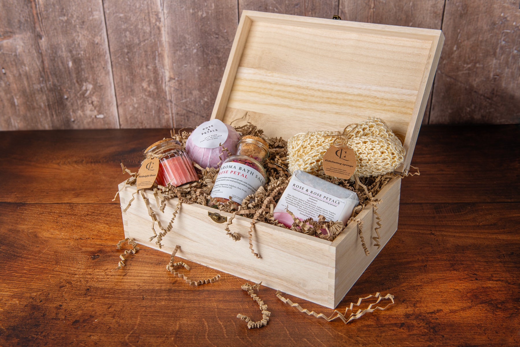 Wooden gift box with bath products on a wooden surface