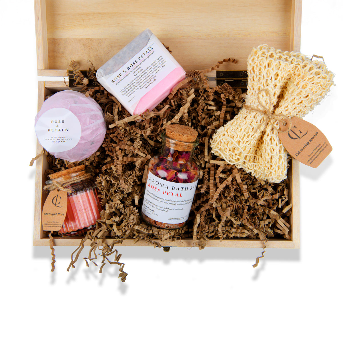 Bath and body products in a wooden gift box with bath bombs, bath salts, and a loofah.