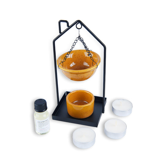 Yellow ceramic bowls with a black metal stand and a bottle on a white background