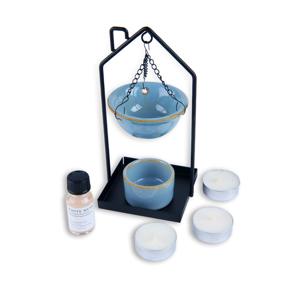 Set of blue ceramic bowls with a black stand and white candles on a white background