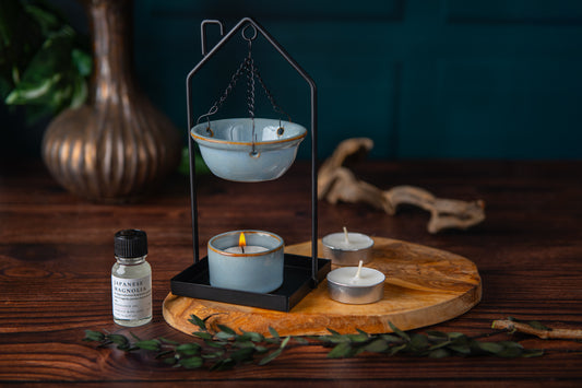 Candle holder with candles and a bottle on a wooden surface