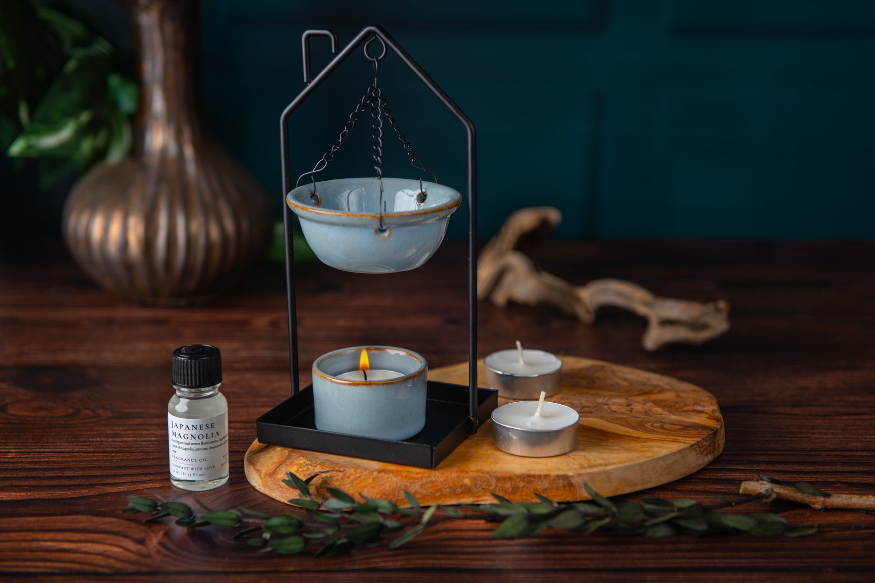 Candle holder with candles and a bottle on a wooden surface