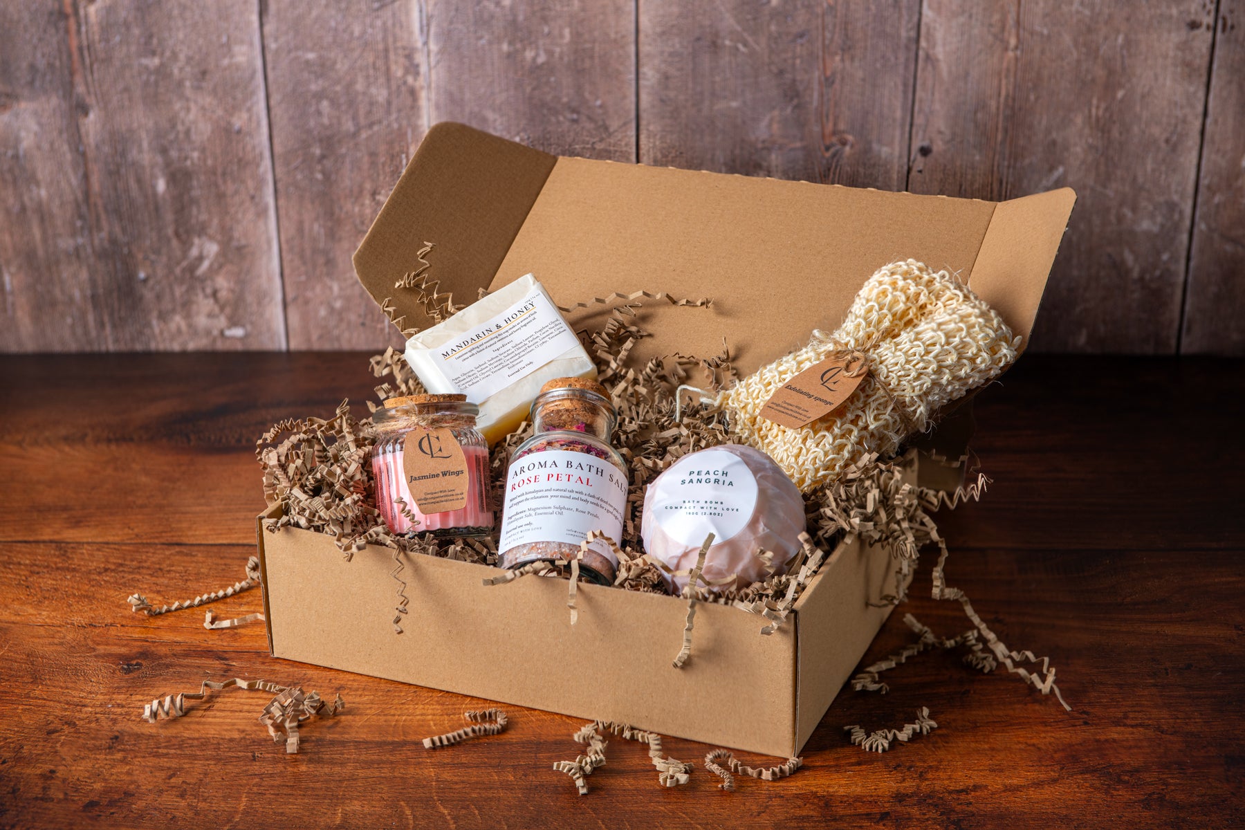 Gift box with bath products on a wooden surface